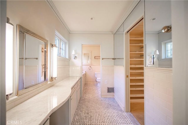 1911 Pepper Dr, Altadena, CA 91001 - bathroom featuring tile walls, plenty of natural light, ornamental molding, vanity, and wainscoting
