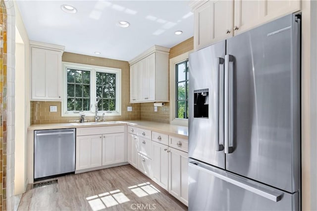1911 Pepper Dr, Altadena, CA 91001 - kitchen with stainless steel appliances, light countertops, plenty of natural light, white cabinets, and recessed lighting