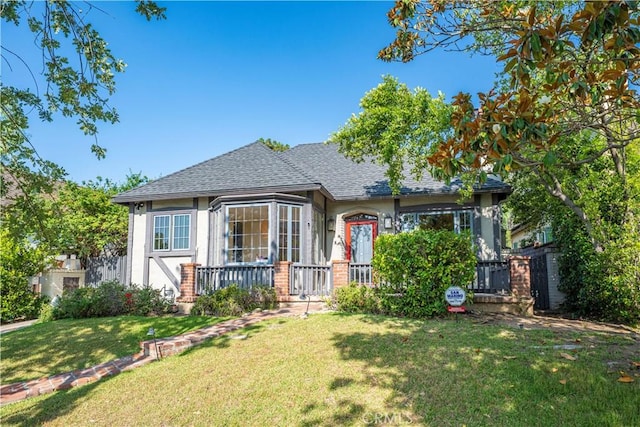 1911 Pepper Dr, Altadena, CA 91001 - view of front facade with a shingled roof, a front yard, stucco siding, and a wooden deck