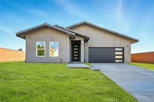 36733 42nd St E, Palmdale, CA 93552 - view of front facade featuring an attached garage, concrete driveway, and stucco siding