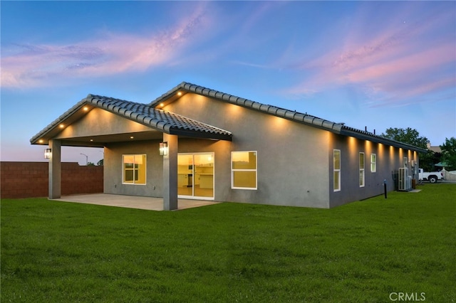 36733 42nd St E, Palmdale, CA 93552 - back of house at dusk with a patio, stucco siding, and a tiled roof