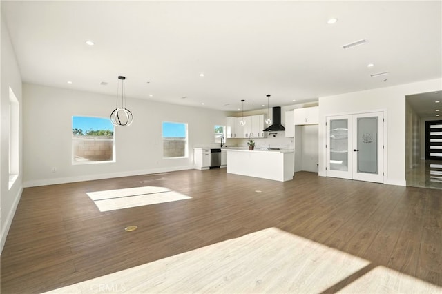 36733 42nd St E, Palmdale, CA 93552 - unfurnished living room featuring dark wood-type flooring and recessed lighting