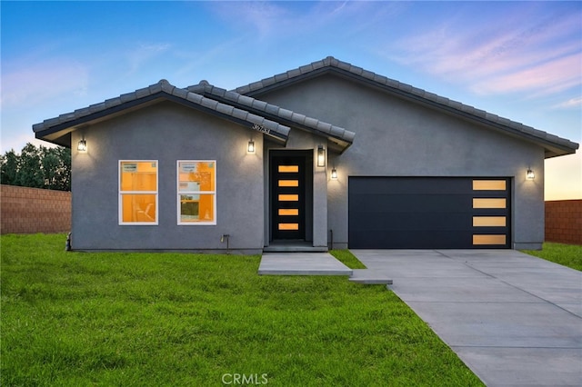 36733 42nd St E, Palmdale, CA 93552 - modern home featuring an attached garage, concrete driveway, and stucco siding