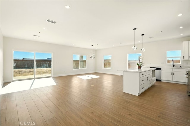36733 42nd St E, Palmdale, CA 93552 - kitchen with appliances with stainless steel finishes, a kitchen island, white cabinets, light countertops, and recessed lighting