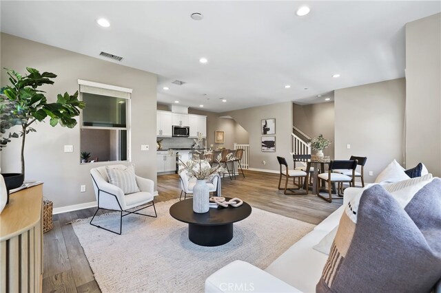 109 Alder Rdg, Lake Forest, CA 92610 - living room featuring stairway, recessed lighting, wood finished floors, and arched walkways