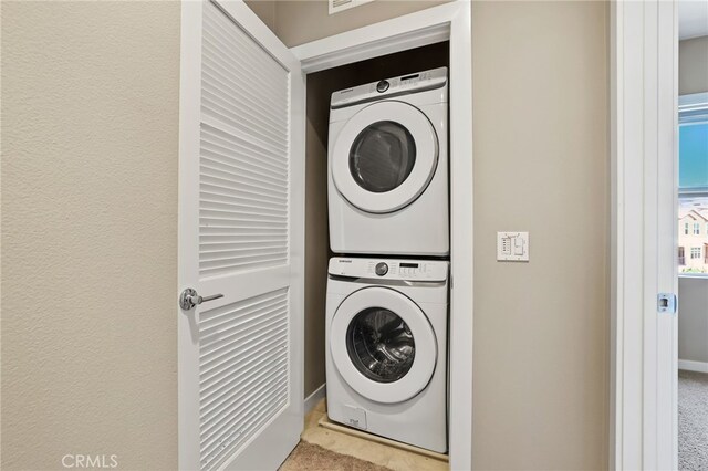 109 Alder Rdg, Lake Forest, CA 92610 - laundry room with stacked washing machine and dryer and carpet floors