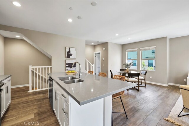 109 Alder Rdg, Lake Forest, CA 92610 - kitchen with dark wood-style flooring, a kitchen bar, white cabinetry, stainless steel dishwasher, and recessed lighting