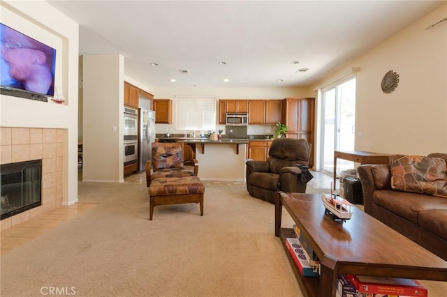 2207 Rockrose St, Palmdale, CA 93551 - living area with a tiled fireplace, light carpet, and recessed lighting