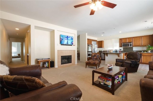 2207 Rockrose St, Palmdale, CA 93551 - living room with light colored carpet, ceiling fan, a tiled fireplace, and recessed lighting