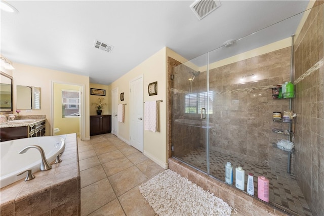 6585 Youngstown St, Chino, CA 91710 - bathroom with vanity, a stall shower, tile patterned floors, and a relaxing tiled tub