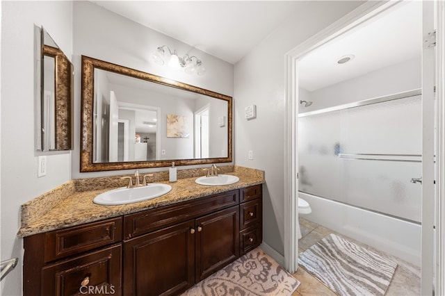 6585 Youngstown St, Chino, CA 91710 - full bath featuring double vanity, combined bath / shower with glass door, and tile patterned floors