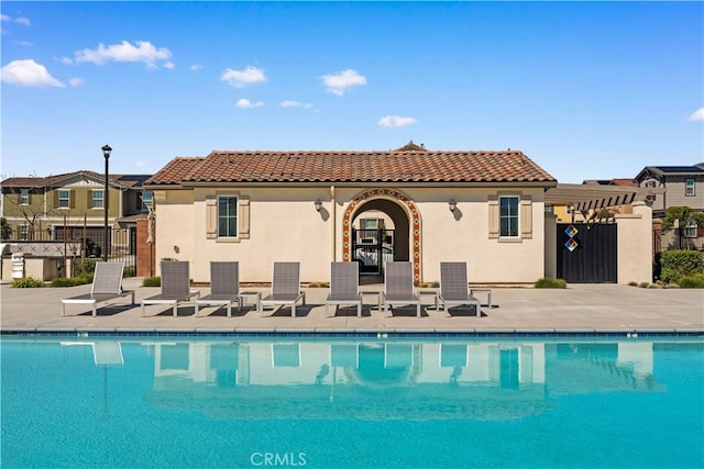 6585 Youngstown St, Chino, CA 91710 - back of house featuring stucco siding, a community pool, and a tiled roof