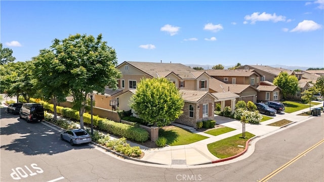 6585 Youngstown St, Chino, CA 91710 - view of front of home with a residential view, stone siding, and a tile roof