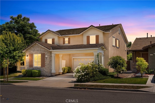 6585 Youngstown St, Chino, CA 91710 - view of front of home with a garage, a tiled roof, driveway, and stucco siding