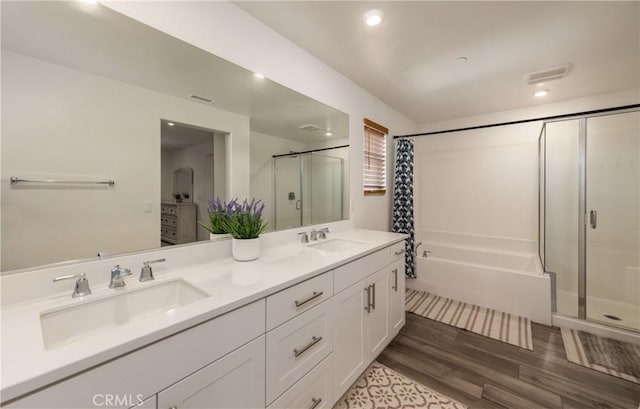 347 Carson Ct, Rialto, CA 92376 - bathroom with a shower stall, a tub, double vanity, and wood finished floors