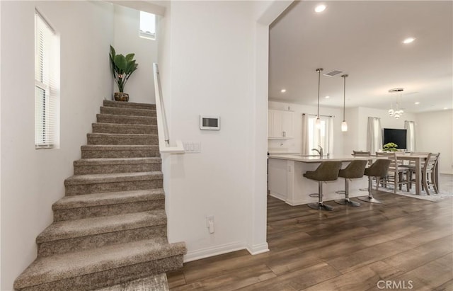 347 Carson Ct, Rialto, CA 92376 - staircase featuring plenty of natural light, wood finished floors, and recessed lighting
