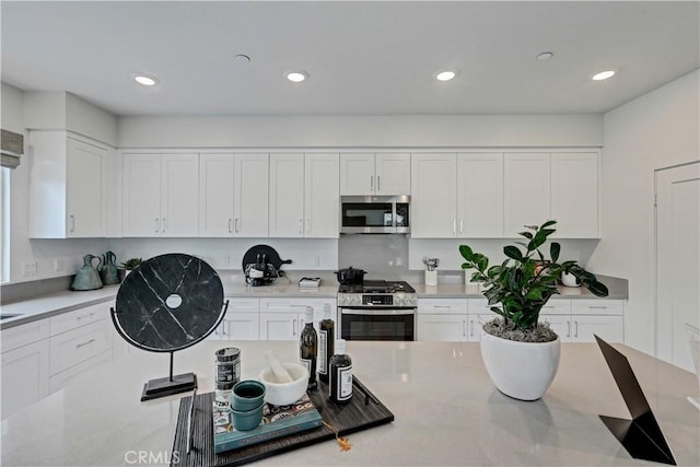 17148 Kent St, Hesperia, CA 92345 - kitchen with stainless steel appliances, white cabinets, light countertops, and recessed lighting
