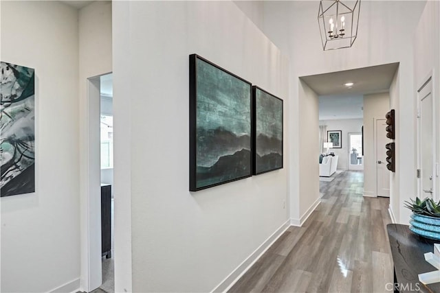 17148 Kent St, Hesperia, CA 92345 - hall with wood finished floors, a high ceiling, and a chandelier