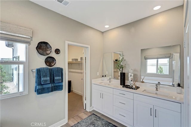 17148 Kent St, Hesperia, CA 92345 - full bath featuring double vanity, wood finished floors, a bath, and a spacious closet