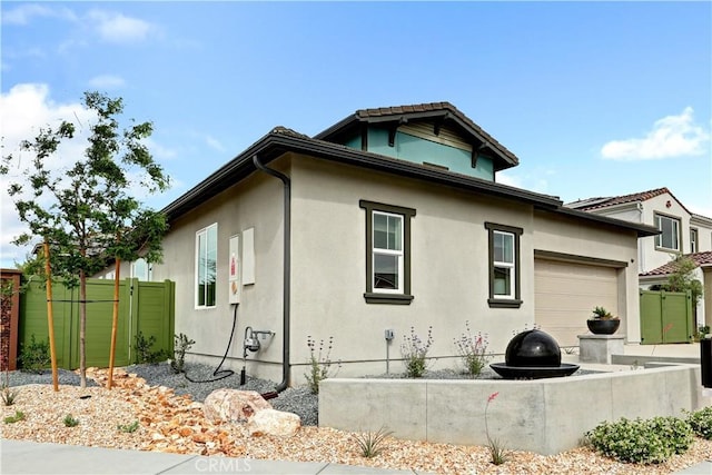 17148 Kent St, Hesperia, CA 92345 - view of property exterior featuring an attached garage and stucco siding