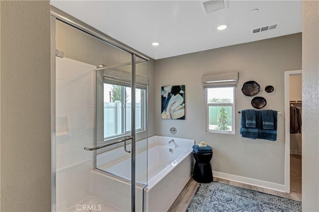 17148 Kent St, Hesperia, CA 92345 - full bath with a bath, a stall shower, wood finished floors, a walk in closet, and recessed lighting