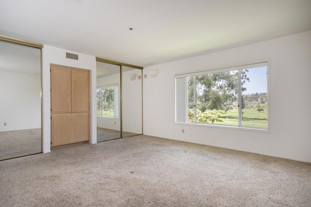 2532 Navarra Dr Unit A, Carlsbad, CA 92009 - unfurnished bedroom featuring multiple closets and carpet flooring