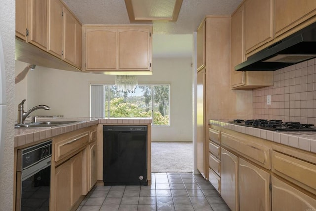 2532 Navarra Dr Unit A, Carlsbad, CA 92009 - kitchen featuring black appliances, tile counters, under cabinet range hood, light brown cabinetry, and tasteful backsplash