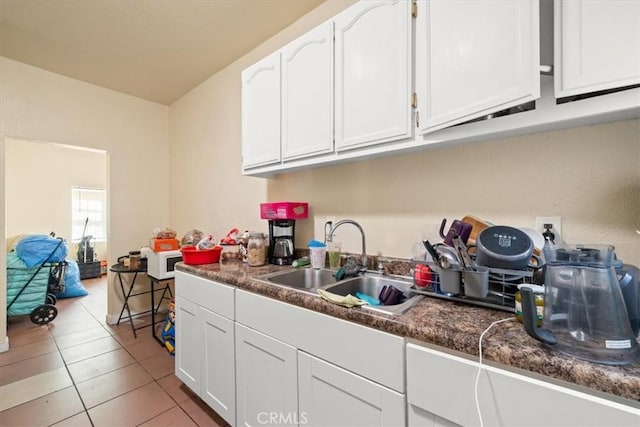 1148 E 43rd, Los Angeles, CA 90011 - kitchen featuring white cabinetry, light tile patterned floors, and dark countertops
