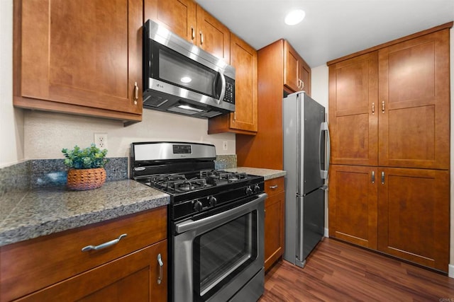 1087 Shadowridge Dr Unit 101, Vista, CA 92081 - kitchen featuring appliances with stainless steel finishes, dark wood-style floors, brown cabinetry, and recessed lighting