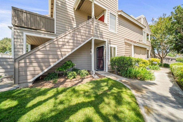 1087 Shadowridge Dr Unit 101, Vista, CA 92081 - view of front of house with stairway, a front lawn, and a balcony