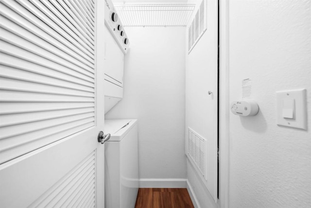 1087 Shadowridge Dr Unit 101, Vista, CA 92081 - laundry area with estacked washer and dryer and dark wood-style floors