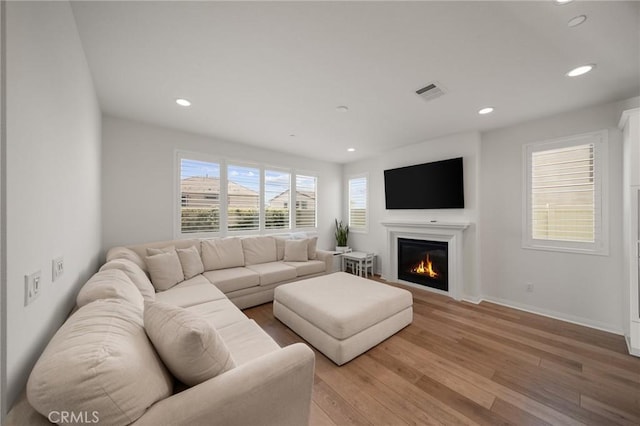 32067 Dawning Rdg, Temecula, CA 92591 - living area featuring light wood-style flooring, recessed lighting, and a glass covered fireplace