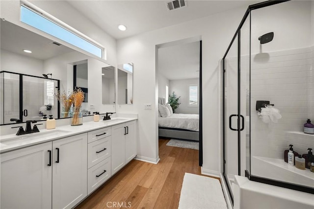 32067 Dawning Rdg, Temecula, CA 92591 - ensuite bathroom featuring double vanity, a stall shower, wood finished floors, and recessed lighting