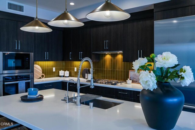 820 Mission St Unit 208, South Pasadena, CA 91030 - kitchen featuring appliances with stainless steel finishes, light countertops, modern cabinets, and pendant lighting