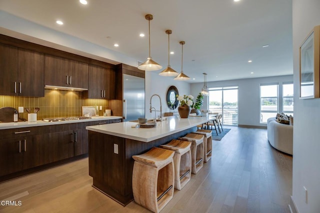 820 Mission St Unit 208, South Pasadena, CA 91030 - kitchen featuring stainless steel appliances, light countertops, recessed lighting, backsplash, and dark brown cabinetry