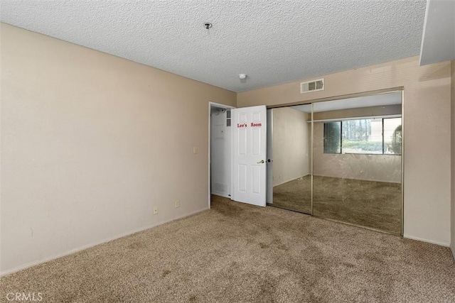 43195 Andrade Ave Unit K, Hemet, CA 92544 - unfurnished bedroom with carpet, a closet, and a textured ceiling
