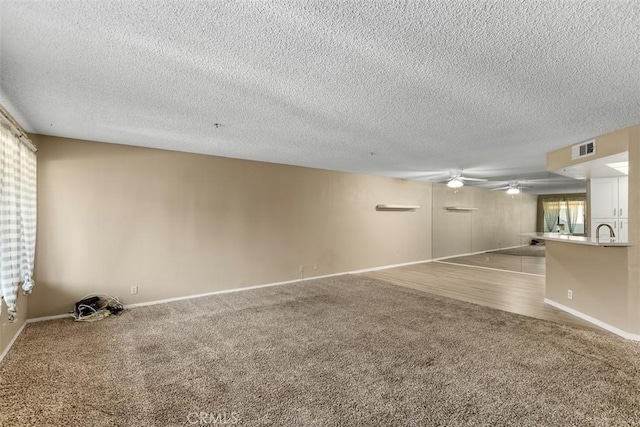 43195 Andrade Ave Unit K, Hemet, CA 92544 - empty room featuring carpet, a ceiling fan, and a textured ceiling