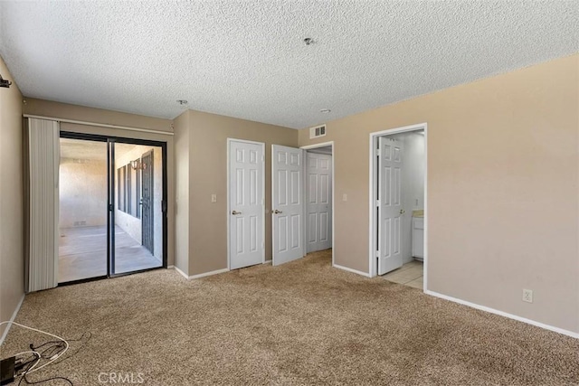 43195 Andrade Ave Unit K, Hemet, CA 92544 - unfurnished bedroom featuring access to exterior, light colored carpet, a textured ceiling, and connected bathroom