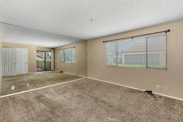 43195 Andrade Ave Unit K, Hemet, CA 92544 - carpeted empty room featuring healthy amount of natural light and a textured ceiling