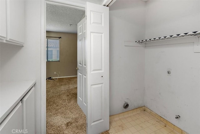 43195 Andrade Ave Unit K, Hemet, CA 92544 - washroom with hookup for an electric dryer, a textured ceiling, and cabinet space