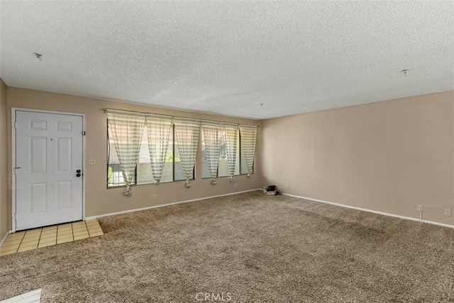 43195 Andrade Ave Unit K, Hemet, CA 92544 - carpeted empty room with a textured ceiling and tile patterned floors