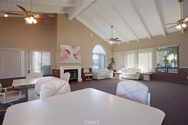 43195 Andrade Ave Unit K, Hemet, CA 92544 - dining space with ceiling fan, high vaulted ceiling, carpet flooring, a glass covered fireplace, and a wooden ceiling with exposed beams