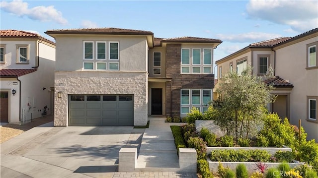 20720 W Liana Ct, Porter Ranch, CA 91326 - view of front of home with concrete driveway, a tiled roof, a garage, stucco siding, and stone siding