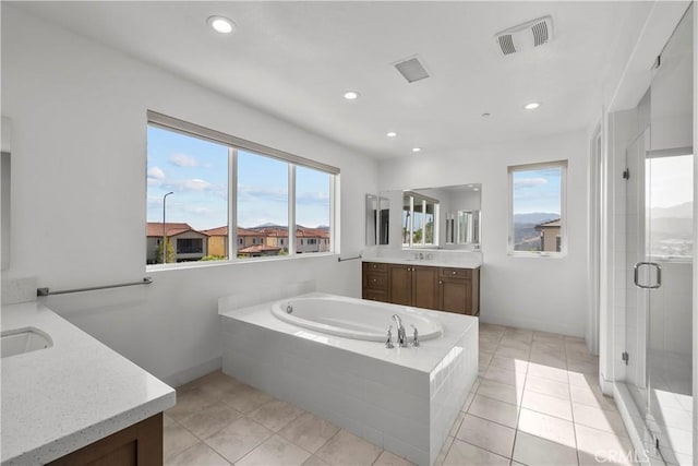 20720 W Liana Ct, Porter Ranch, CA 91326 - bathroom featuring two vanities, a shower stall, a bath, recessed lighting, and tile patterned floors