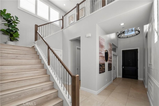 20720 W Liana Ct, Porter Ranch, CA 91326 - stairway featuring a high ceiling, tile patterned floors, and a chandelier