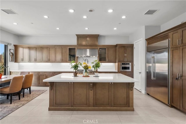 20720 W Liana Ct, Porter Ranch, CA 91326 - kitchen with stainless steel appliances, a kitchen island, recessed lighting, light countertops, and light tile patterned flooring
