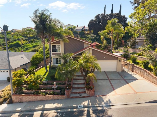 439 Acaso Dr, Walnut, CA 91789 - view of property hidden behind natural elements with driveway, an attached garage, and stucco siding