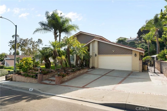 439 Acaso Dr, Walnut, CA 91789 - view of front of home featuring a garage, concrete driveway, a gate, and stucco siding
