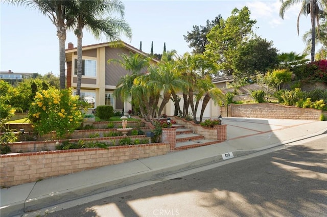 439 Acaso Dr, Walnut, CA 91789 - obstructed view of property featuring stucco siding and concrete driveway