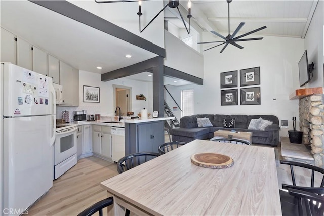 362 Old Mammoth Rd Unit 47, Mammoth Lakes, CA 93546 - dining room with ceiling fan, light wood finished floors, beam ceiling, stairs, and a stone fireplace